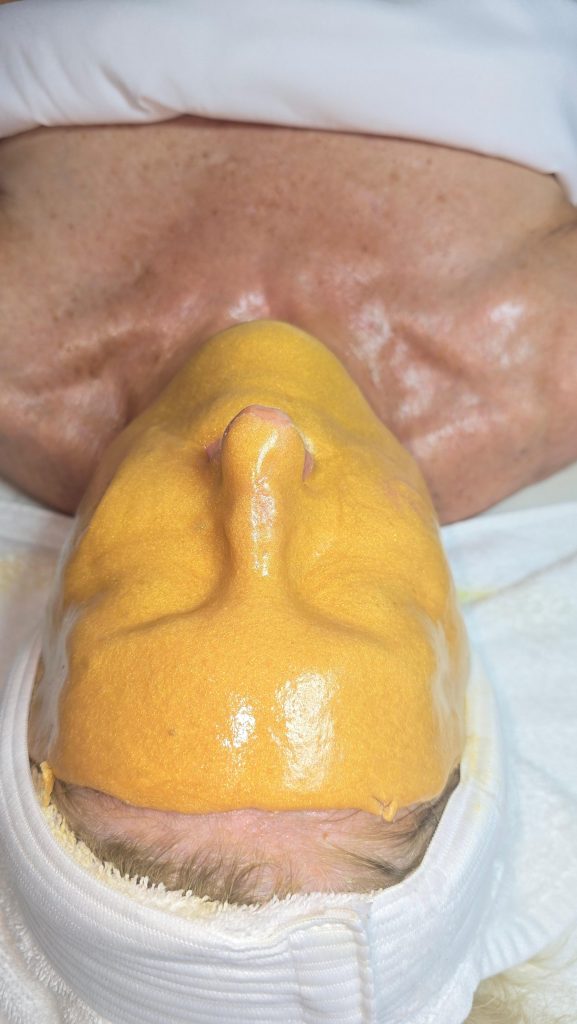 PolyLuronic™ Jelly Masks by Luminous Skin Lab | Professional vs Amazon Jelly Masks: Ingredient and Performance Differences esthetician applying professional jelly mask during facial treatment